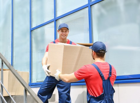 Man with van loading furniture for a move in Putney